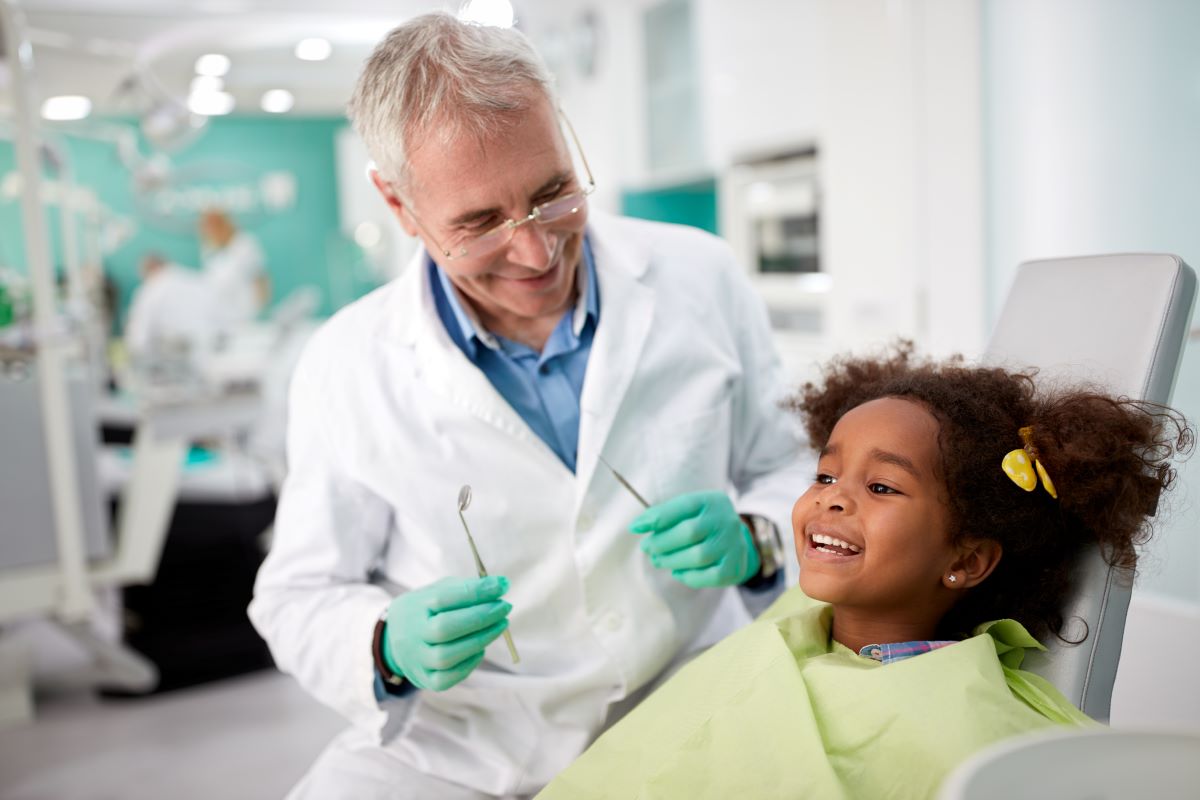 Image of a pediatric dentist with child
